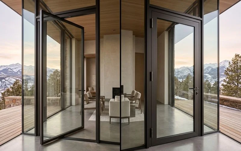 Detail comparing frame width of a pivot vs hinged door